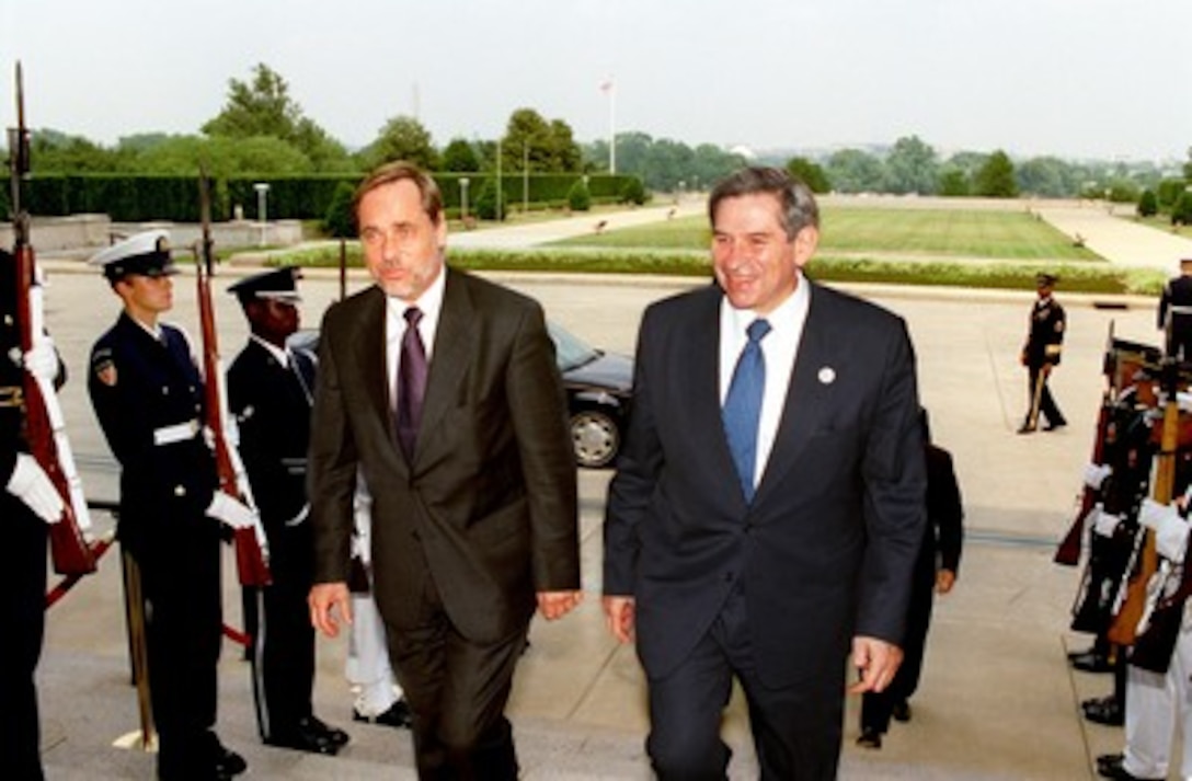 Norwegian Minister of Foreign Affairs Jan Petersen (left) is escorted by Deputy Secretary of Defense Paul Wolfowitz through an honor cordon and into the Pentagon on June 10, 2002. Petersen and Wolfowitz will meet to discuss a range of bilateral security issues. 