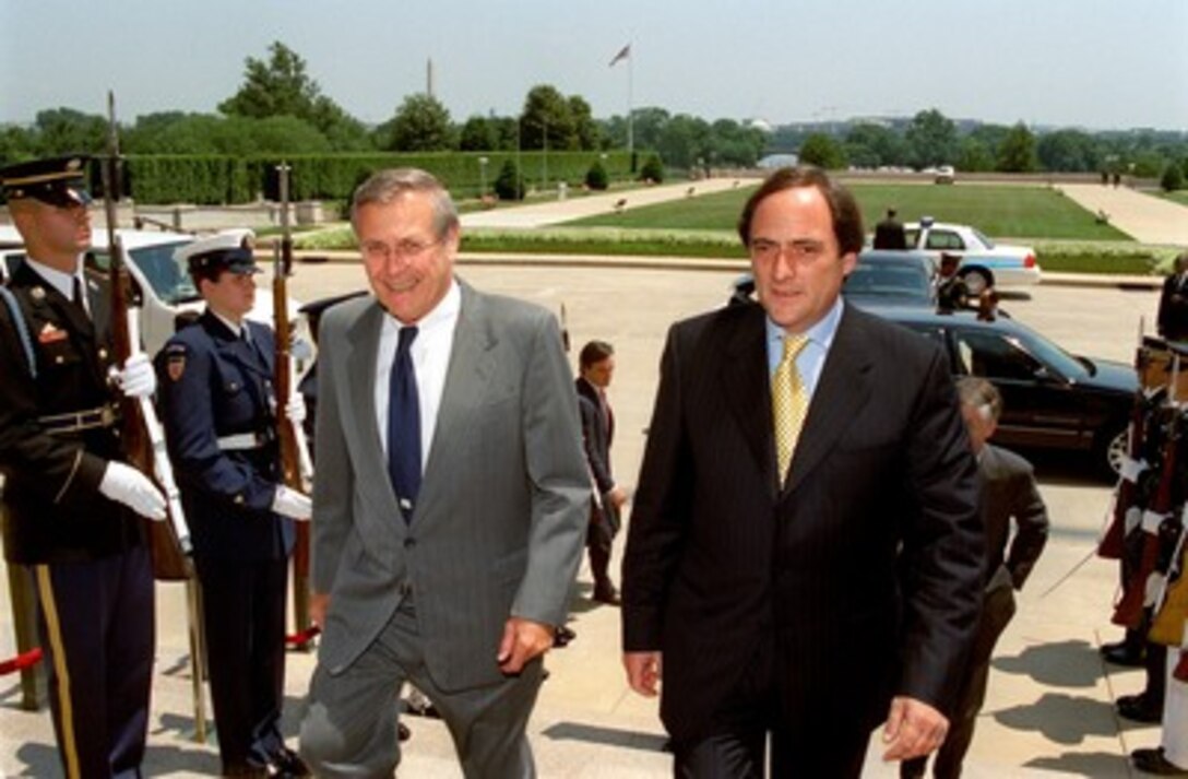 Secretary of Defense Donald H. Rumsfeld (left) escorts Portuguese Minister of State and Defense Paulo Portas (right) into the Pentagon on June 18, 2002. The two defense leaders will meet to discuss bilateral security issues. 