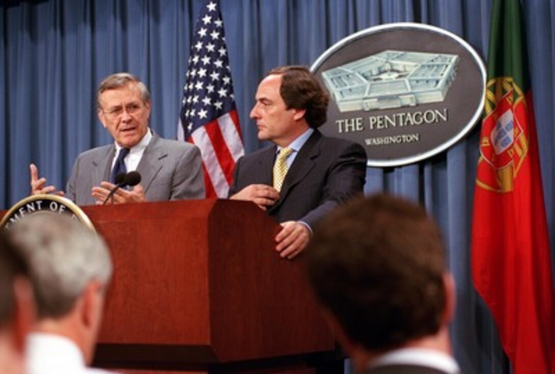 Secretary of Defense Donald H. Rumsfeld (left) and Portuguese Minister of State and Defense Paulo Portas (right) hold a joint press conference in the Pentagon on June 18, 2002. Rumsfeld and Portas met earlier to discuss various bilateral security issues. 