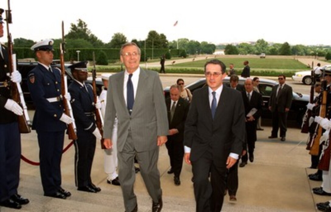 Secretary of Defense Donald H. Rumsfeld (left) escorts Colombian President-elect Alvaro Uribe through an honor cordon and into the Pentagon on June 18, 2002. Uribe will meet with Rumsfeld, Chairman of the Joint Chiefs of Staff Gen. Richard B. Myers, and other senior Department of Defense officials to discuss a range of bilateral security issues. 