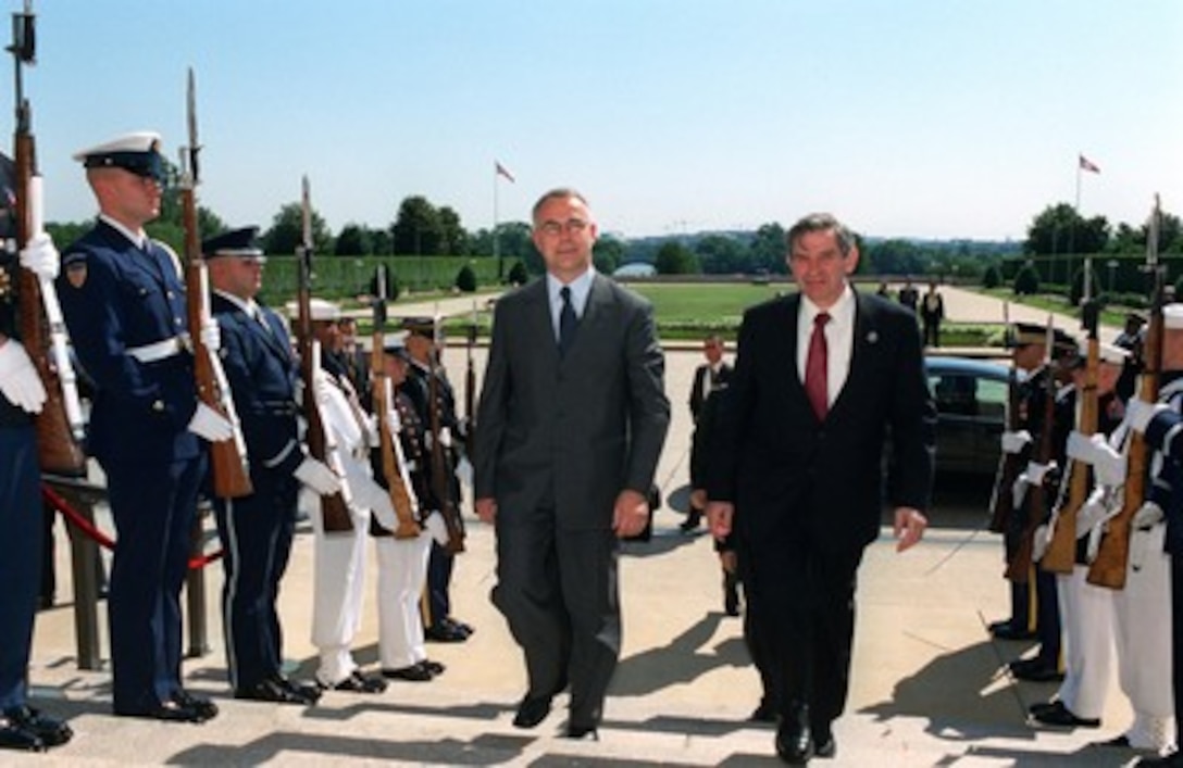 Croatian Minister of Defense Jozo Rados (left) is escorted by Deputy Secretary of Defense Paul D. Wolfowitz through an honor cordon and into the Pentagon on June 17, 2002. The two leaders will meet to discuss defense issues of mutual interest. 