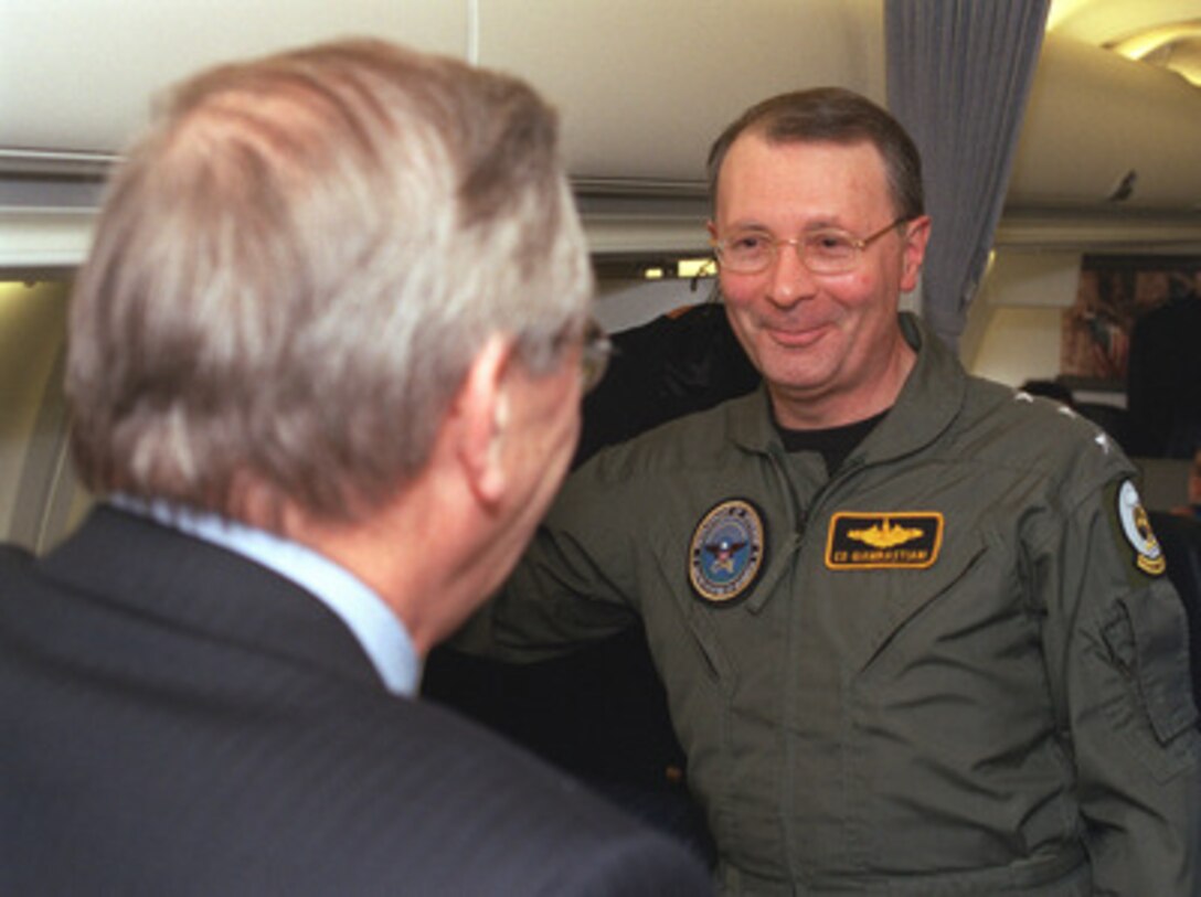 Secretary of Defense Donald H. Rumsfeld (left) talks with Senior Military Assistant Vice Adm. Edmund Giambastiani, U.S. Navy, as they wait to takeoff from Moscow International Airport on April 29, 2002. Rumsfeld and Giambastiani are returning to Washington, DC., after meeting with Russian Minister of Defense Sergey Ivanov concerning reductions in the nuclear arsenals of both nations. 