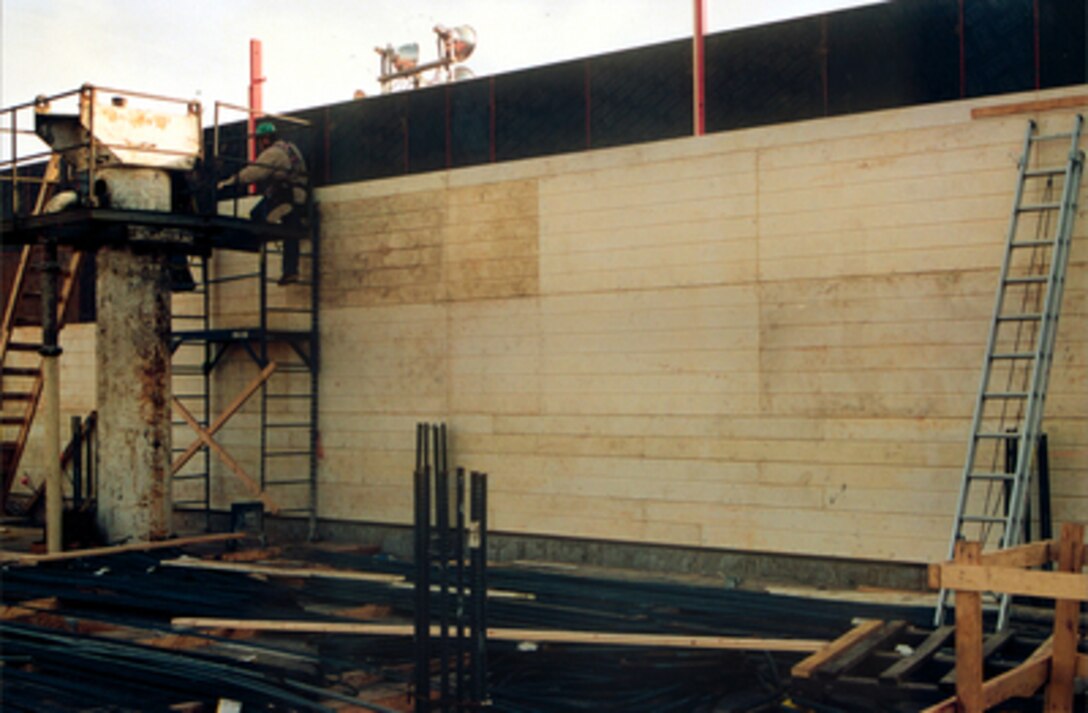 Pentagon construction workers place sections of plastic formwork liner in which concrete will be poured to create a section of wall at the Pentagon on Feb. 12, 2002. The plastic liner is molded to replicate the feel and look of the original 1941 wooden plank formwork used in building the Pentagon. Crews are working nearly around-the-clock as they pour concrete for floors and walls to replace those damaged in the Sept. 11, 2001, terrorist attack on the building. 