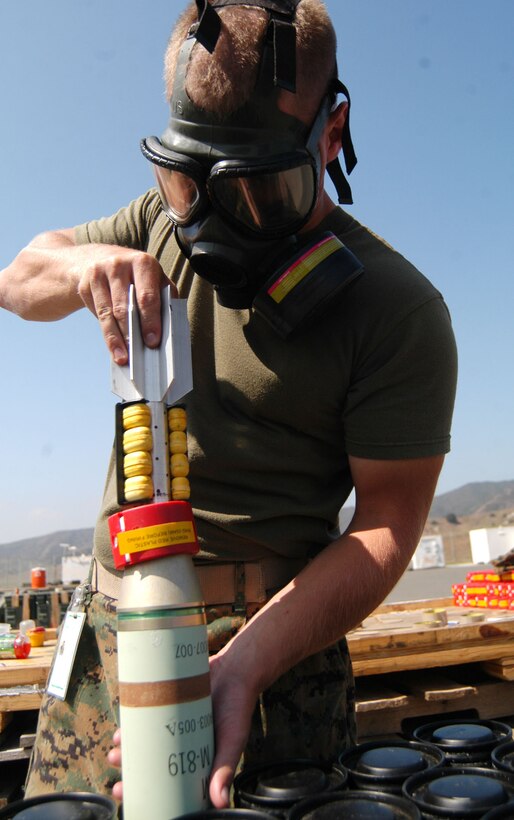 Pfc. Galvin J. Murphy, an ammunition technician with Combat Service Support Group 15, 1st Force Service Support Group, places a detoxified mortar round into its container Aug. 17. He, along with nine other ammo. techs, was at Las Pulgas to make the rounds safe to use in Iraq. (Photo by Lance Cpl. Ray Lewis)