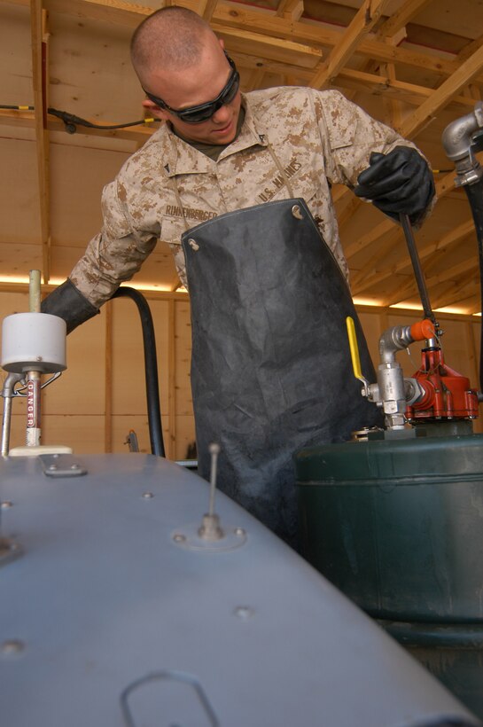 AL TAQADDUM, Iraq (March 30, 2005) - Lance Cpl. Kyle A. Rinkenberger, airframe mechanic and native of Bloomington, Ill., fills up a Pioneer unmanned aerial vehicle during a daily maintenance inspection. Rinkenberger and the Marines of Marine Unmanned Aerial Vehicle Squadron 2 are supporting the 2nd Marine Expeditionary Force (Forward) by keeping the dedicated reconnaissance aircraft flying high above the Al Anbar province in support of Operation Iraqi Freedom.