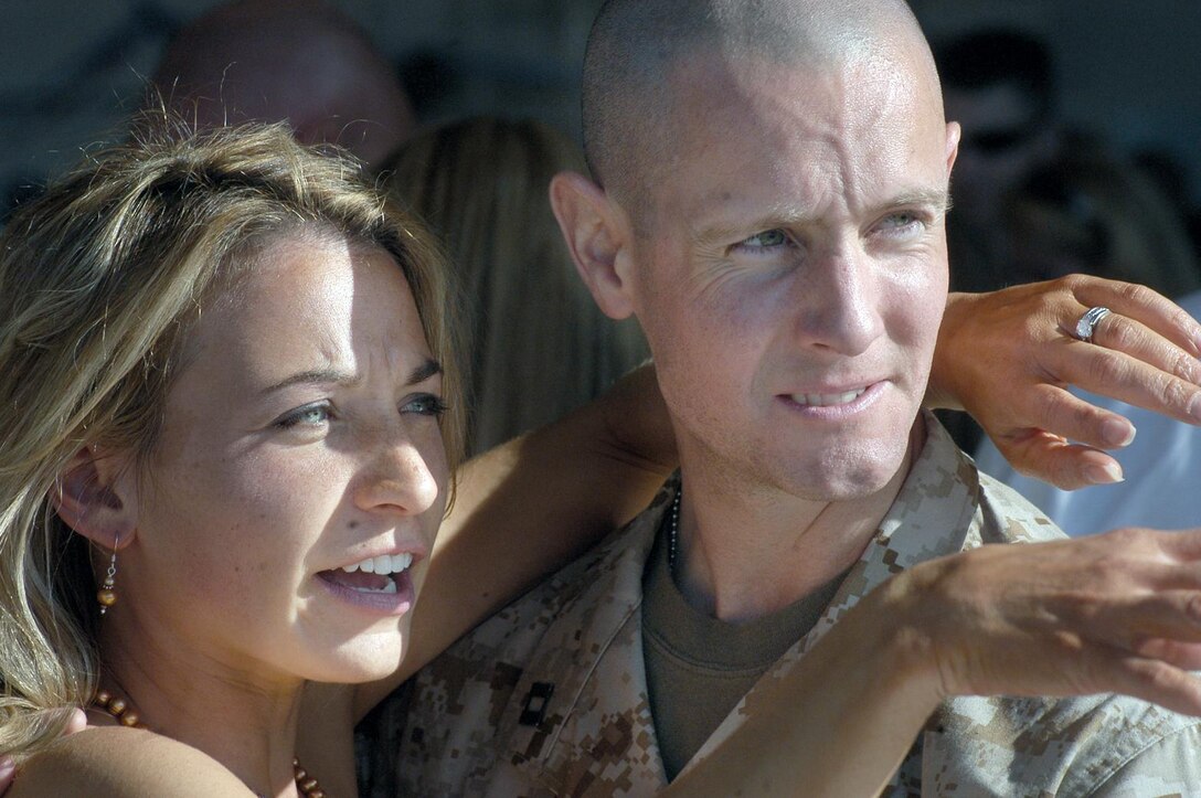 Navy Lt. Bryan J. Keenan, flight surgeon for Marine Light Attack Helicopter Squadron-369, holds his wife (Jennifer) as she talks about the homecoming in Hangar Seven of Marine Corps Air Station, Camp Pendleton Sunday. The squadron is returning from a seven month deployment to Operation Iraqi Freedom.