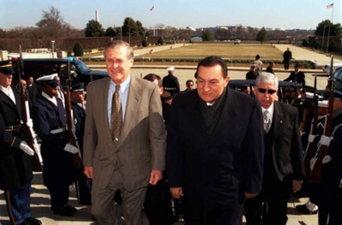 Egyptian President Hosni Mubarak (right) is escorted into the Pentagon by Secretary of Defense Donald H. Rumsfeld (left) on March 5, 2002. Mubarak and Rumsfeld will meet to discuss the war on terrorism, the Israeli-Palestinian conflict and other regional security issues. 