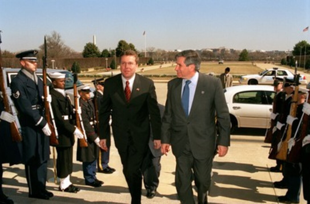 Austrian Minister of Defense Herbert Scheibner (left) is escorted by Deputy Secretary of Defense Paul Wolfowitz (right) through an honor cordon and into the Pentagon on March 5, 2002. Scheibner and Wolfowitz will meet to discuss regional security issues. 
