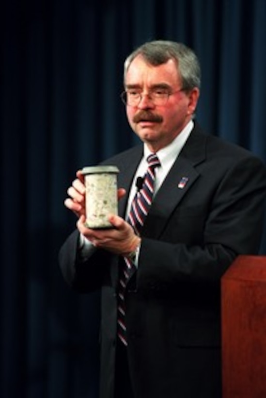 Pentagon Renovation Program Manager Walker Lee Evey shows a core sample of concrete taken from the damaged area of the Pentagon during a press briefing on March 7, 2002. Evey reported on the progress of the reconstruction, dubbed The Phoenix Project, of the 400,000 square foot area that was structurally damaged by the terrorist attack on Sept. 11, 2001. 