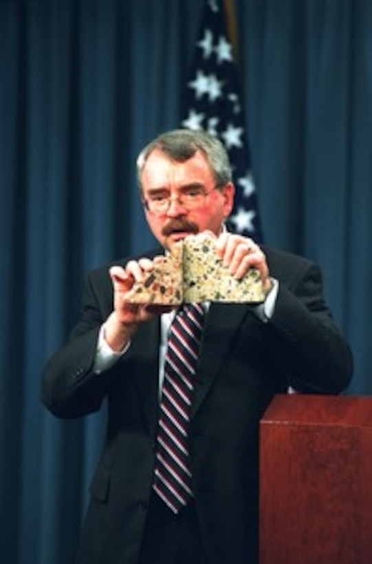 Pentagon Renovation Program Manager Walker Lee Evey holds up saw-cut cross sections of concrete from the Pentagon support columns showing numerous micro-fractures during a briefing on March 7, 2002. Evey reported on the progress of the reconstruction, dubbed The Phoenix Project, of the 400,000 square foot area that was structurally damaged by the terrorist attack on Sept. 11, 2001. 