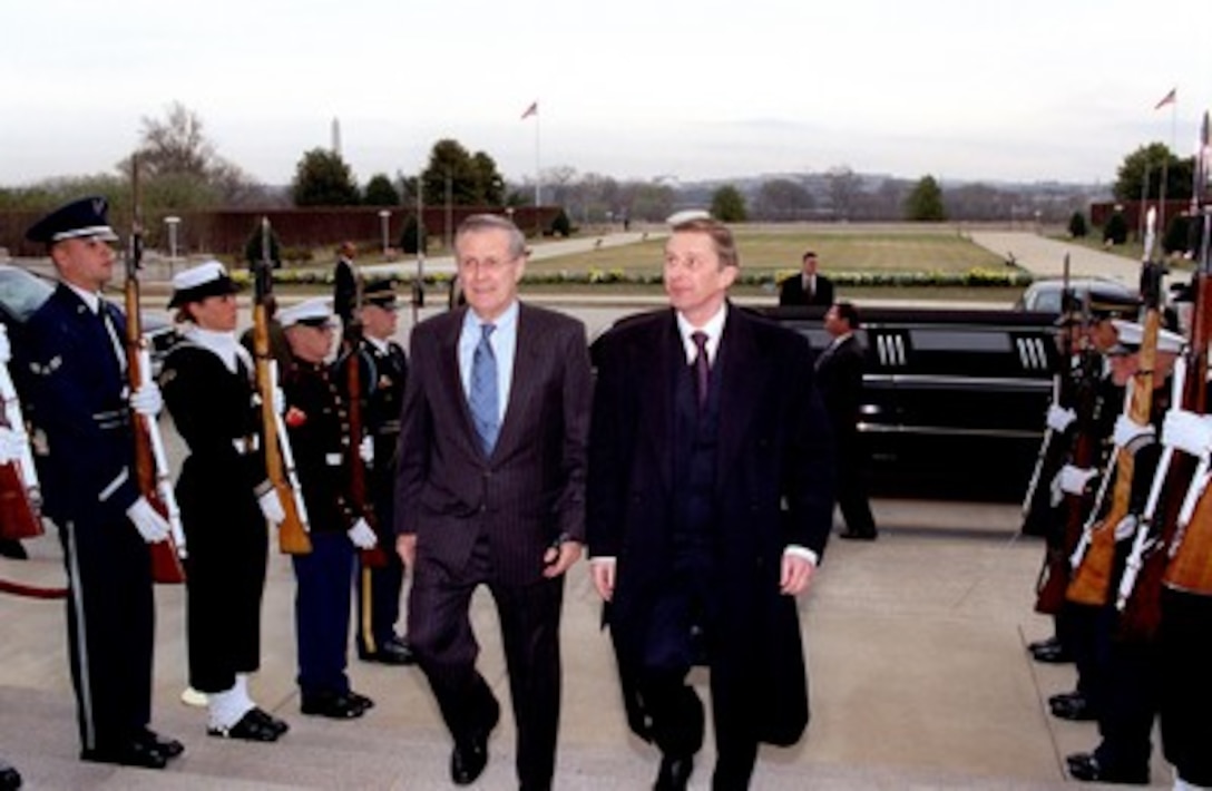 Secretary of Defense Donald H. Rumsfeld (left) escorts Russian Minister of Defense Sergey Ivanov through an honor cordon and into the Pentagon on March 12, 2002. The two men and their top advisors will meet to discuss a broad range of security issues of interest to both nations. 