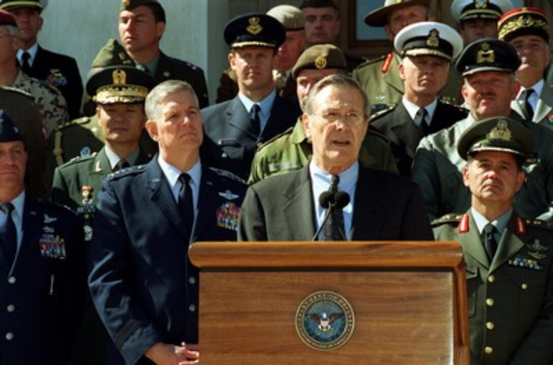 Secretary of Defense Donald H. Rumsfeld responds to a reporter's question during a media availability on the steps of the Pentagon on March 11, 2002. Rumsfeld was joined by Chairman of the Joint Chiefs of Staff Gen. Richard B. Myers, U.S. Air Force, and military representatives from 29 countries of the worldwide coalition against terrorism. The representatives met with Rumsfeld and toured the reconstruction site where the terrorist attack on the Pentagon occurred on Sept. 11, 2001. 