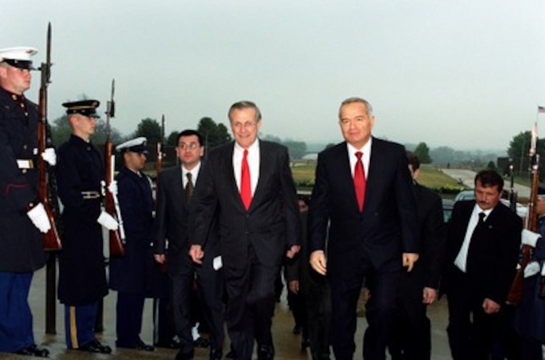 Uzbekistan President Islom Karimov (right) is escorted by Secretary of Defense Donald H. Rumsfeld through an honor cordon and into the Pentagon on March 13, 2002. Karimov and Rumsfeld will meet to discuss the war on terrorism and regional security issues. 