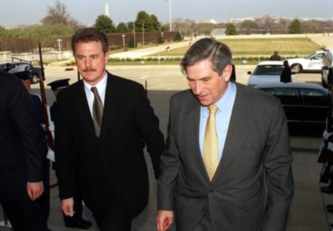 Latvian Minister of Defense Girts Valdis Kristovskis (left) is escorted by Deputy Secretary of Defense Paul Wolfowitz through an honor cordon and into the Pentagon on March 14, 2002. Kristovskis and the defense ministers from Estonia and Lithuania and will meet with Wolfowitz to discuss regional security issues of interest to all four nations. 