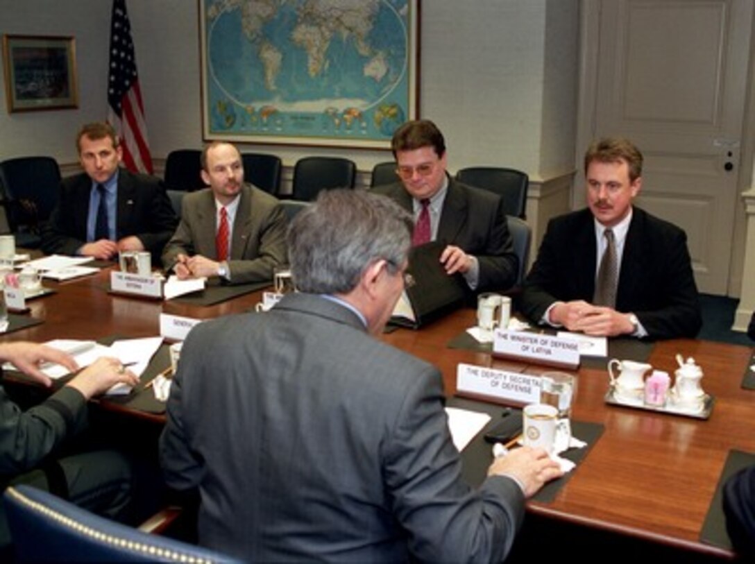 The ambassadors and defense ministers of Estonia, Latvia and Lithuania participate in regional security discussions in the Pentagon on March 14, 2002. Deputy Secretary of Defense Paul Wolfowitz (foreground) is hosting the meeting of (left to right) Vygaudas Usackas, Lithuanian ambassador to the U.S.; Sven Jurgenson, Estonian ambassador to the U.S.; Linas Linkevicius, minister of defense of Lithuania, and Girts Valdis Kristovskis, minister of defense of Latvia. 