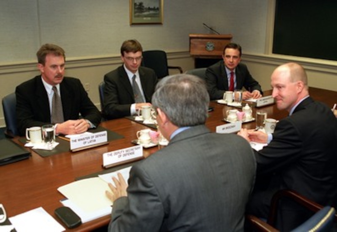 The ambassadors and defense ministers of Estonia, Latvia and Lithuania participate in regional security discussions in the Pentagon on March 14, 2002. Deputy Secretary of Defense Paul Wolfowitz (foreground) is hosting the meeting of (left to right) Girts Valdis Kristovskis, minister of defense of Latvia; Sven Mikser, minister of defense of Estonia, and Avis Ronin, the Latvian ambassador to the U.S. Seated to the right of Wolfowitz is Ian Brzezinski, deputy assistant secretary of defense for European and NATO policy. 