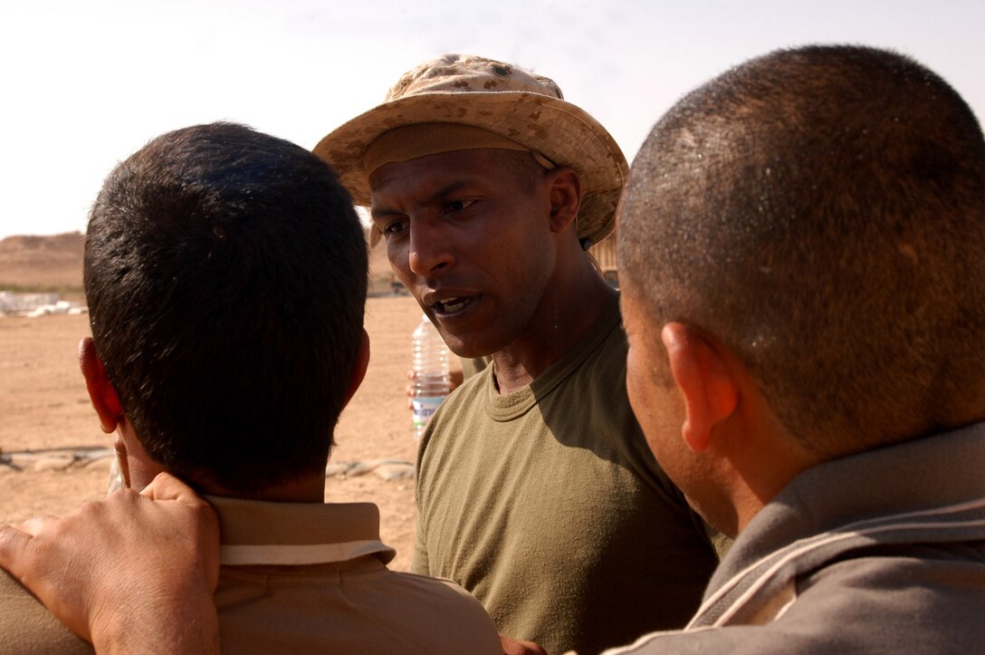 AL ASAD, Iraq (April 14, 2005) - During a training session on pressure points, Chris asks an Iraqi Border Patrol student if his partner is doing the technique right. Chris serves an interpreter for the Marine and civilian law enforcement instructors at the Regional Iraqi Police and Border Patrol Academy here.