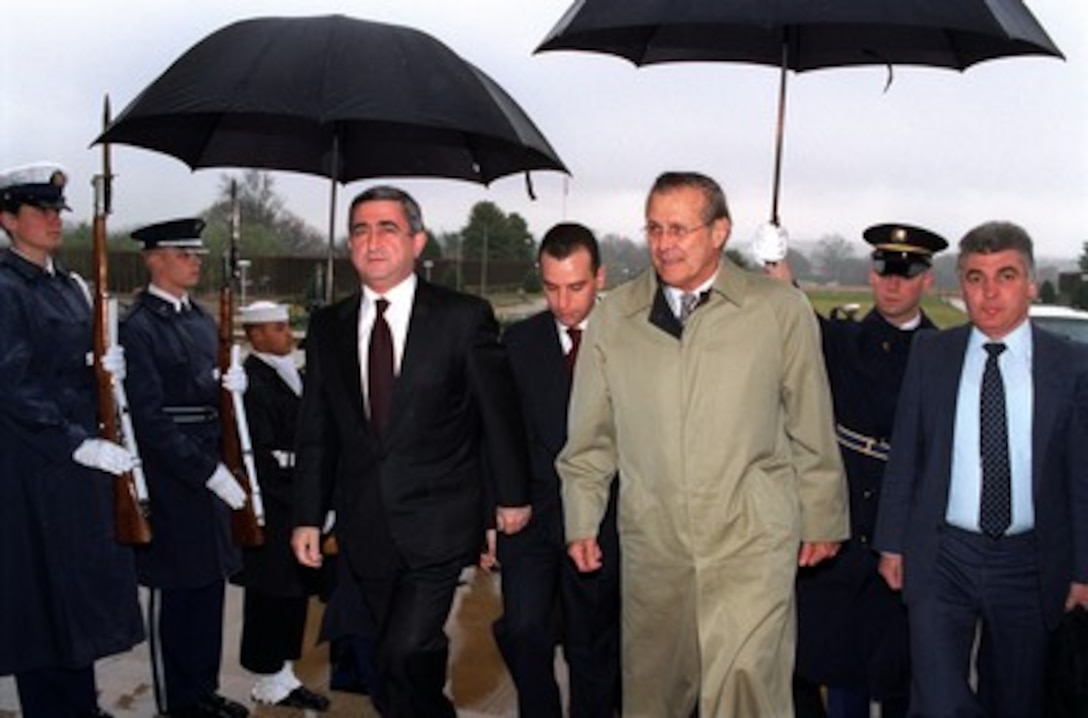 Minister of Defense Serchik Sarkisyan (left), of the Republic of Armenia, arrives at the Pentagon on March 20, 2002, for a meeting with Secretary of Defense Donald H. Rumsfeld (center). Sarkisyan and Rumsfeld will meet to discuss a broad spectrum of security issues. 