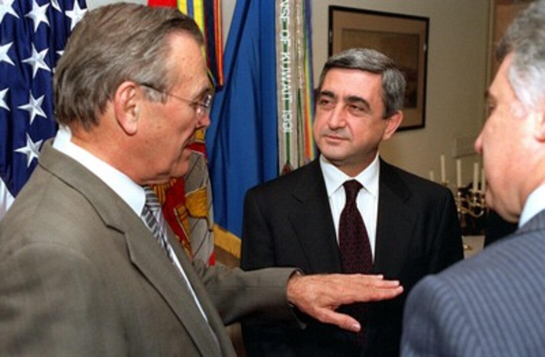 Secretary of Defense Donald H. Rumsfeld (left) meets in his Pentagon office with Armenian Minister of Defense Serchik Sarkisyan (center) on March 20, 2002. Rumsfeld and Sarkisyan are meeting to discuss a broad spectrum of security issues. 