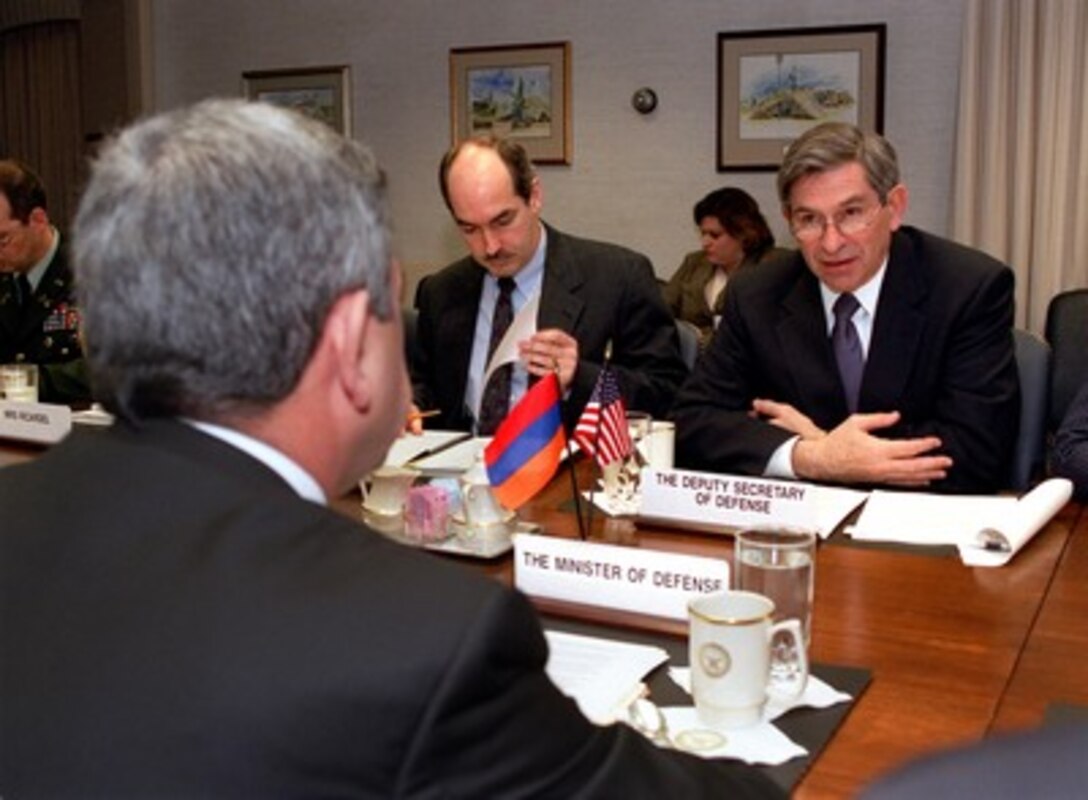 Deputy Secretary of Defense Paul Wolfowitz (right) meets with Minister of Defense Serchik Sarkisyan (foreground) in the Pentagon on March 20, 2002. Wolfowitz, Sarkisyan and Assistant Secretary of Defense for International Security Affairs J. D. Crouch (center) are meeting to discuss a broad spectrum of security issues. 