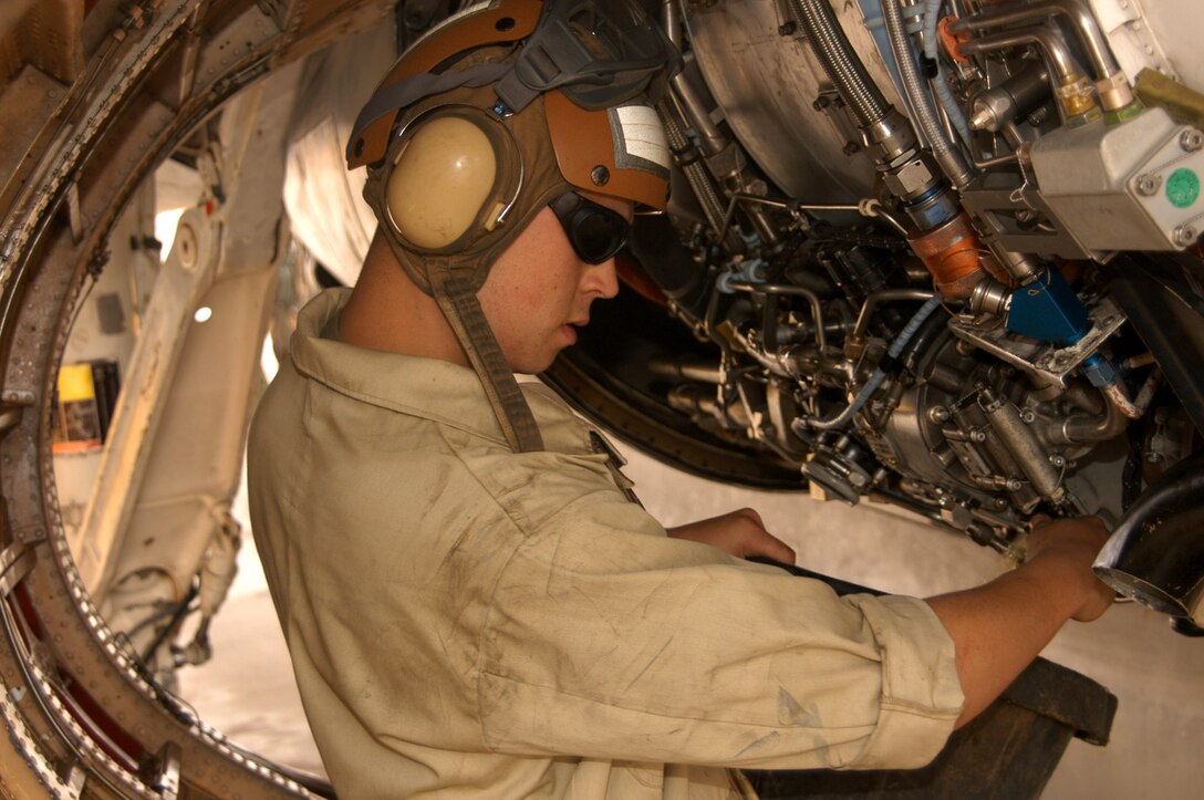 AL ASAD, Iraq (April 13, 2005) - Lance Cpl. Steve D. Weber, powerlines mechanic and native of Copley, Ohio, collects an oil sample from the engine of a EA-6B Prowler soon after it returned from a mission. The maintenance Marines can determine the 'health' of an engine by analyzing the content of its oil.