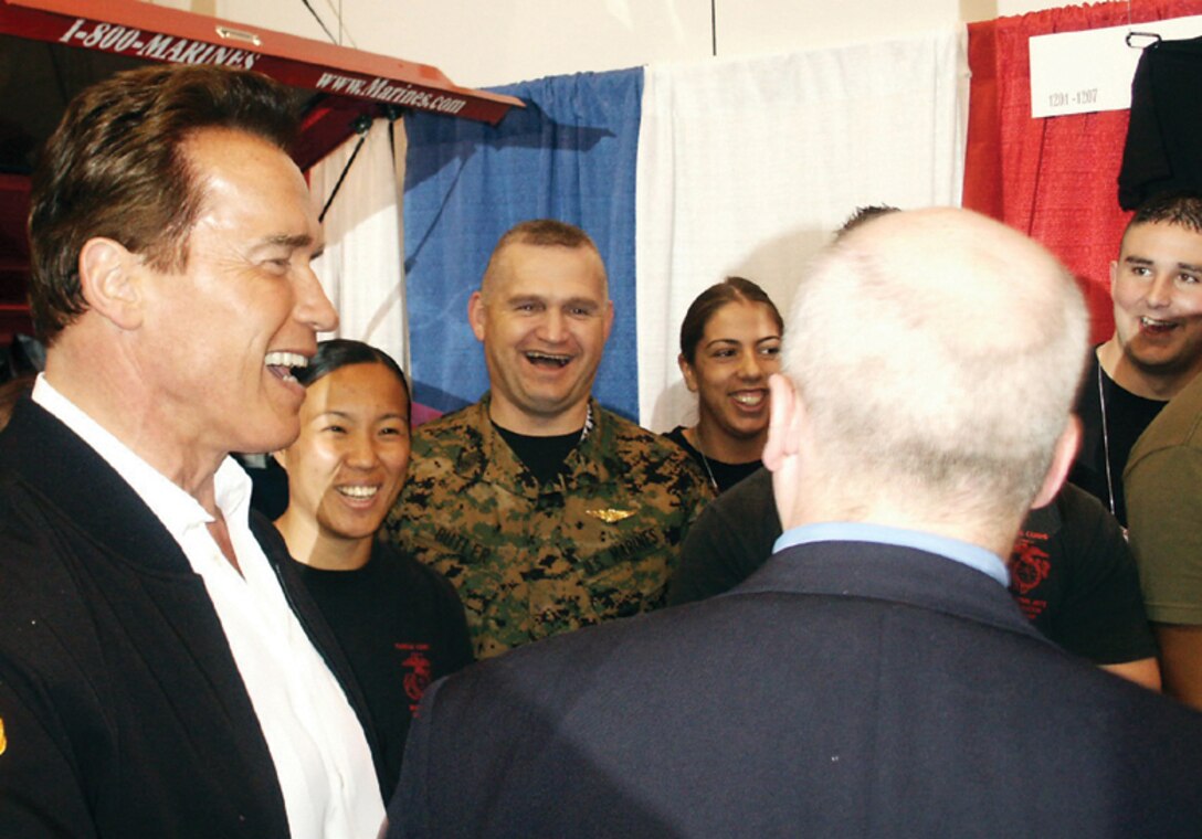 Governor Arnold Schwarzenegger, R-Calif., jokes with the Marines at the booth.  He does his best to visit the Marines' booth each year.