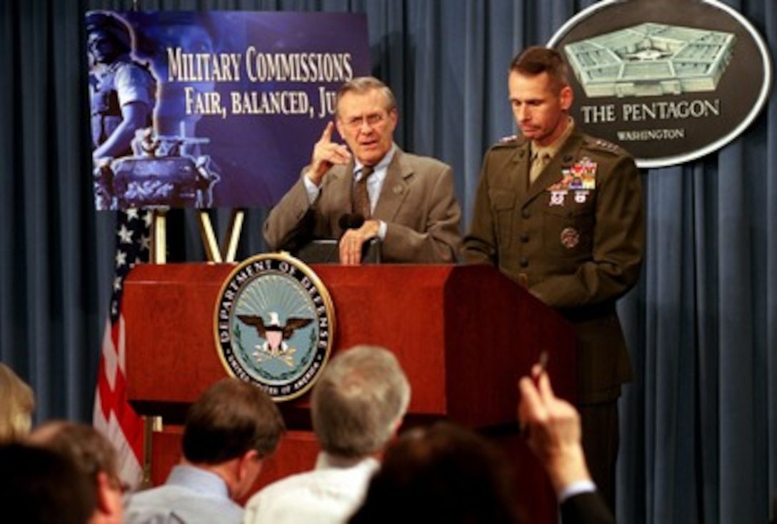 Secretary of Defense Donald H. Rumsfeld answers a reporter's question concerning the guidelines for military commissions in the trials of detainees from the war on terrorism during a March 21, 2002, press briefing. Marine Gen. Peter Pace, vice chairman of the Joint Chiefs of Staff joined Rumsfeld for the briefing in the Pentagon. 
