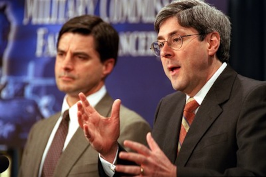 Under Secretary of Defense for Policy Douglas Feith (right) explains to reporters at the Pentagon on March 21, 2002, some of the policy decisions that went into formulating the rules for military commissions in the trials of detainees from the war on terrorism. Department of Defense General Counsel William Haynes joined Feith for the briefing. 
