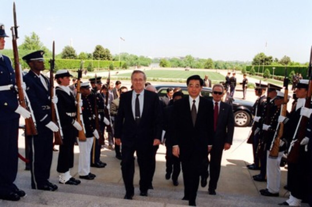 Secretary of Defense Donald H. Rumsfeld (left) escorts Vice President Hu Jintao, of China, through an honor cordon and into the Pentagon on May 1, 2002. Rumsfeld and Hu will meet to discuss defense issues of mutual interest. 