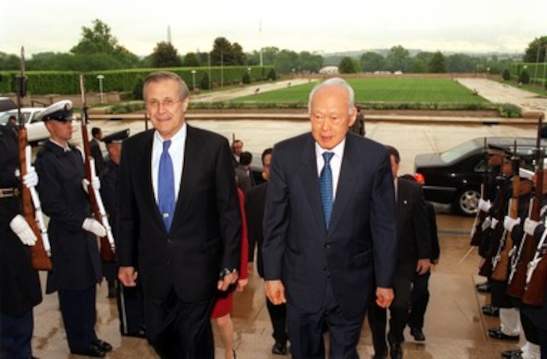 Secretary of Defense Donald H. Rumsfeld (left) escorts Senior Minister Lee Kuan Yew, of Singapore, through an honor cordon and into the Pentagon on May 2, 2002. Rumsfeld and Lee will meet to discuss bilateral security issues including the war on terrorism. 