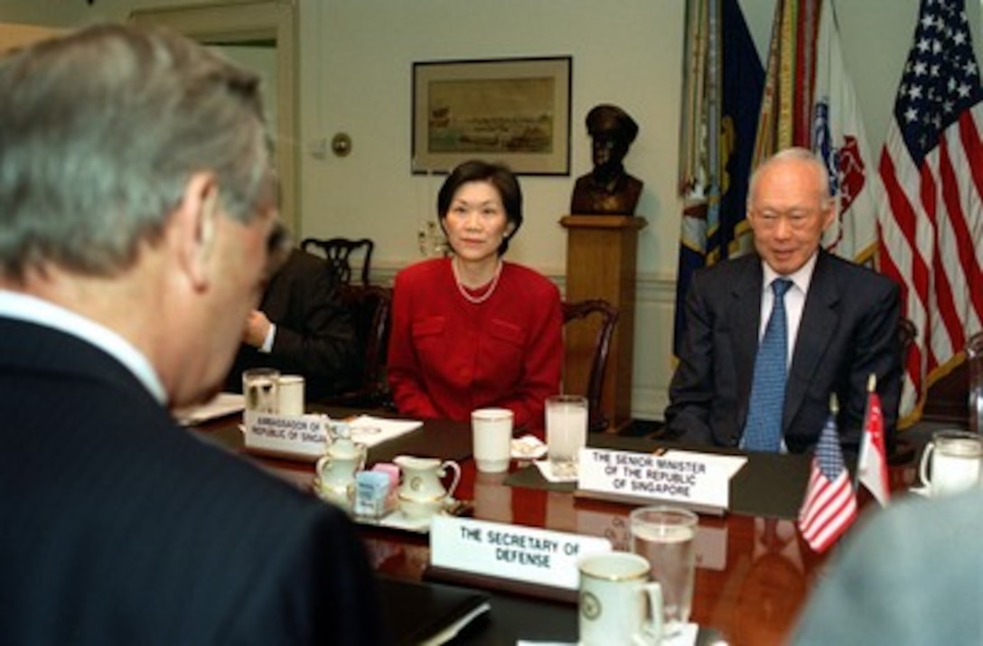 Singapore's Senior Minister Lee Kuan Yew (right) meets with Secretary of Defense Donald H. Rumsfeld (foreground) in the Pentagon on May 2, 2002. Lee and Rumsfeld are meeting to discuss a range of bilateral security issues including the war on terrorism. Also participating in the talks is Singapore's Ambassador to the U.S. Chan Heng Chee (center). 