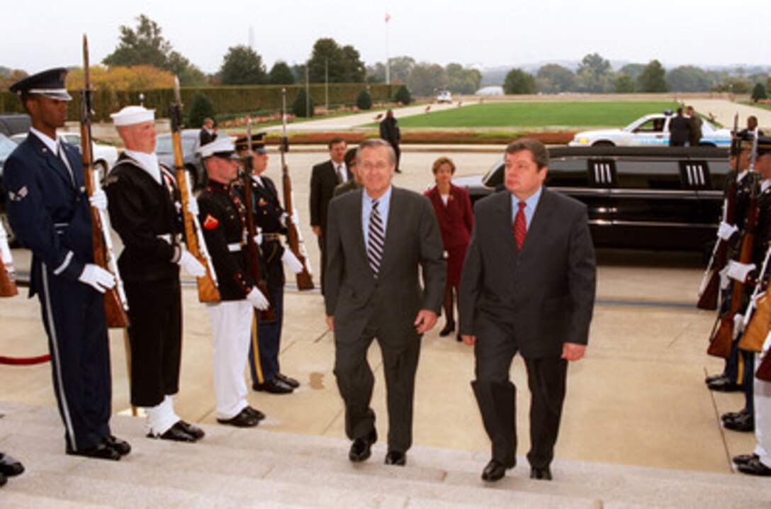 Secretary of Defense Donald H. Rumsfeld (left) escorts Ukrainian Minister of Defense Gen. Volodymyr Shkidchenko through a joint service honor cordon and into the Pentagon on October 25, 2002. The two defense leaders will meet to discuss a range of bilateral security issues. 