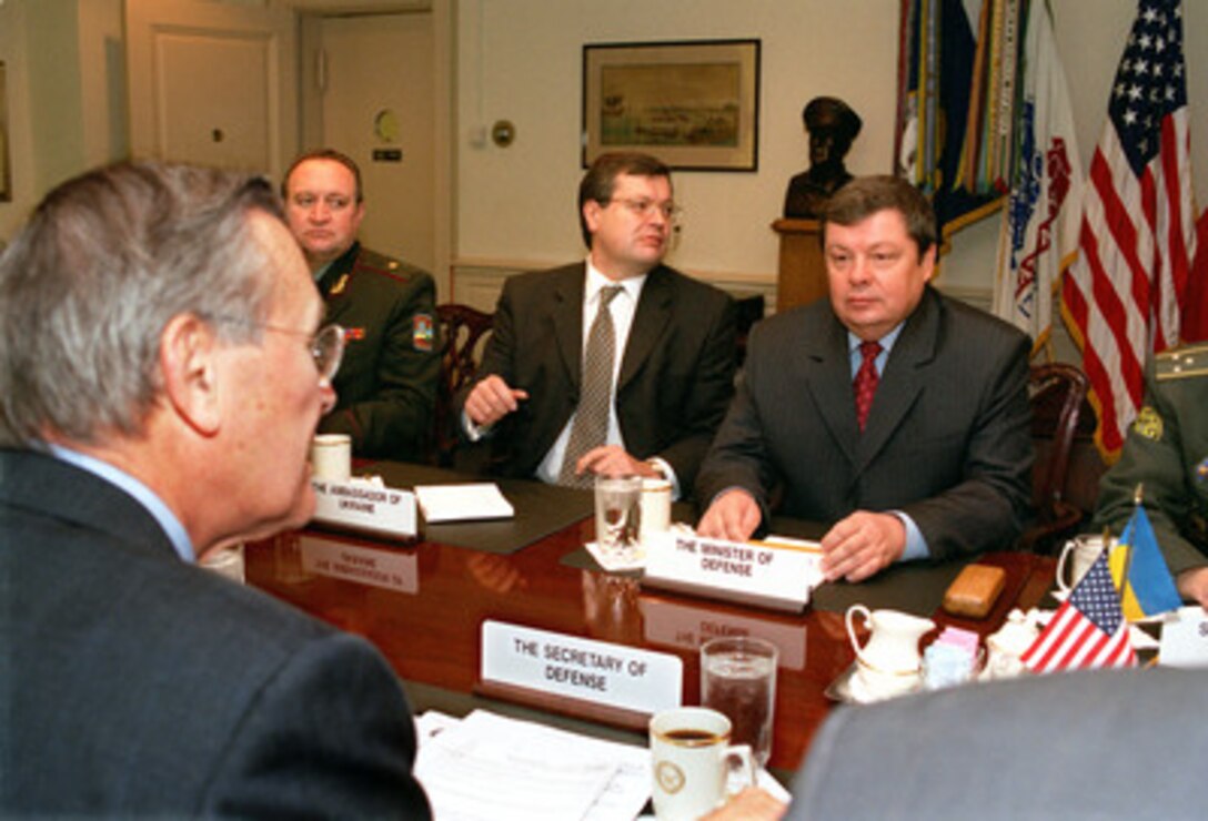 Ukrainian Minister of Defense Gen. Volodymyr Shkidchenko (right) meets with Secretary of Defense Donald H. Rumsfeld (left foreground) in the Pentagon on Oct. 25, 2002, to discuss a broad range of bilateral security issues. Ukrainian Ambassador to the United States Konstantin Hryshchenko (2nd from right) joined in the talks. 