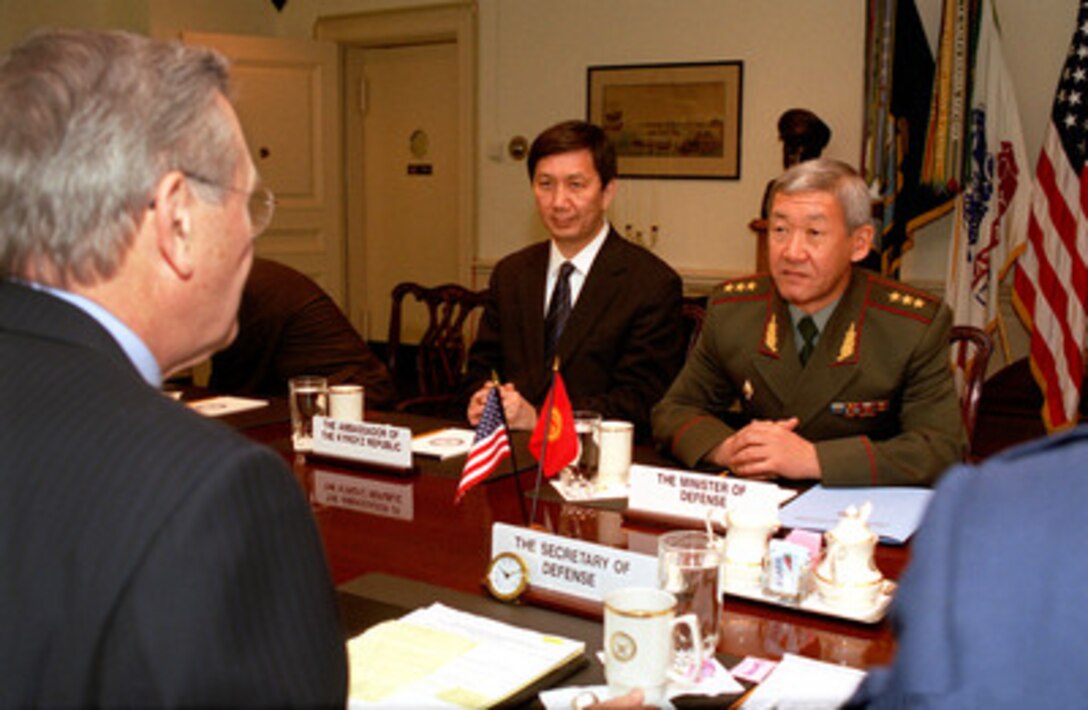 Kyrgyzstan's Minister of Defense Col. Gen. Esen Topoyev (right) meets with Secretary of Defense Donald H. Rumsfeld (left foreground) in the Pentagon on Nov. 7, 2002. Topoyev and Rumsfeld are meeting to discuss a range of bilateral security issues. Also participating in the talks is Kyrgyzstan's Ambassador to the United States Bakyt Abdrisayev (center). 