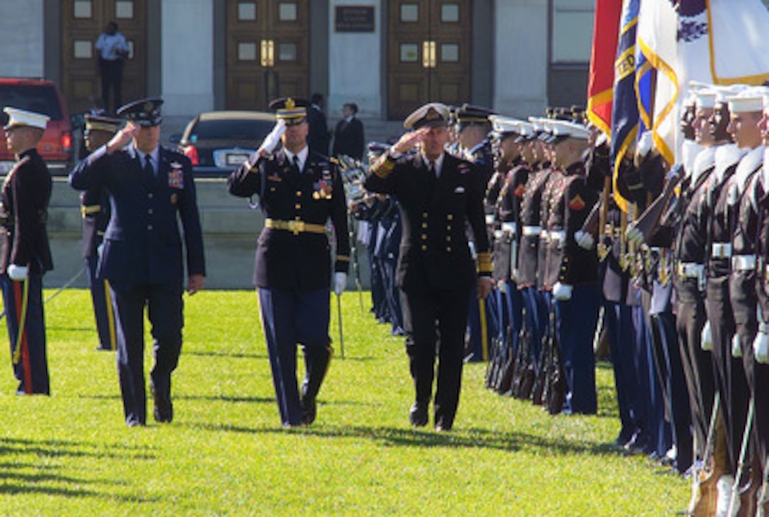 Adm. Sir Michael Boyce, Chief of the Defence Staff, United Kingdom, (right of center) reviews the troops during a full honor arrival ceremony Nov. 14, 2002. Adm. Boyce is escorted by Gen. Richard B. Myers, Chairman of the Joint Chiefs of Staff, and Lt. Col. Tracy Bryant, Commander of Troops. 