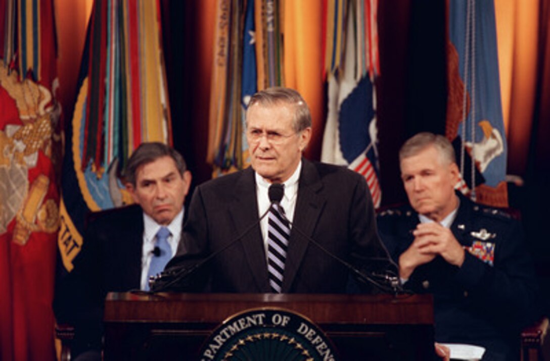 Secretary of Defense Donald H. Rumsfeld makes his opening remarks at the Pentagon Town Hall meeting on Nov. 12, 2002. Deputy Secretary of Defense Paul Wolfowitz (left), Chairman of the Joint Chiefs of Staff Gen. Richard B. Myers (right), U.S. Air Force, and Vice Chairman of the Joint Chiefs of Staff Gen. Peter Pace, U.S. Marine Corps (not shown) joined Rumsfeld in responding to questions from military members and civilian employees of the Department of Defense. 