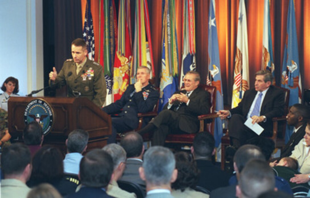 Vice Chairman of the Joint Chiefs of Staff Gen. Peter Pace (left), U.S. Marine Corps, responds to a question during a Pentagon Town Hall meeting on Nov. 12, 2002. Secretary of Defense Donald H. Rumsfeld (2nd from right) hosted the meeting to answer questions from military members and civilian employees of the Department of Defense. Chairman of the Joint Chiefs of Staff Gen. Richard B. Myers (2nd from left), U.S. Air Force, and Deputy Secretary of Defense Paul Wolfowitz (right) joined Rumsfeld in responding to questions. 