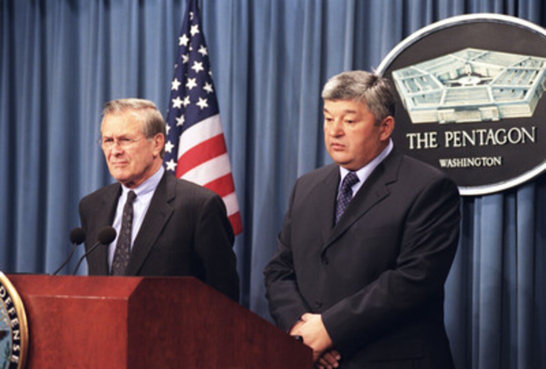 Secretary of Defense Donald H. Rumsfeld listens as Kazakhstan's Minister of Defense General-Colonel Mukhtar Alytnbaev responds to a reporter's question during a joint press briefing in the Pentagon on Nov. 14, 2002. The two leaders met earlier to discuss defense issues of mutual interest. 