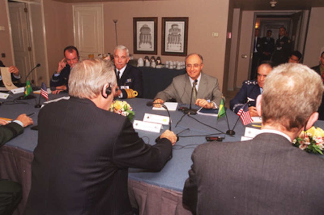 Secretary of Defense Donald H. Rumsfeld (foreground) hosts a bilateral meeting with Brazil's Minister of Defense Dr. Geraldo Magela da Cruz Quintao in Santiago, Chile, on Nov.18, 2002. The defense leaders are in Santiago, Chile attending the Defense Ministerial of the Americas. 