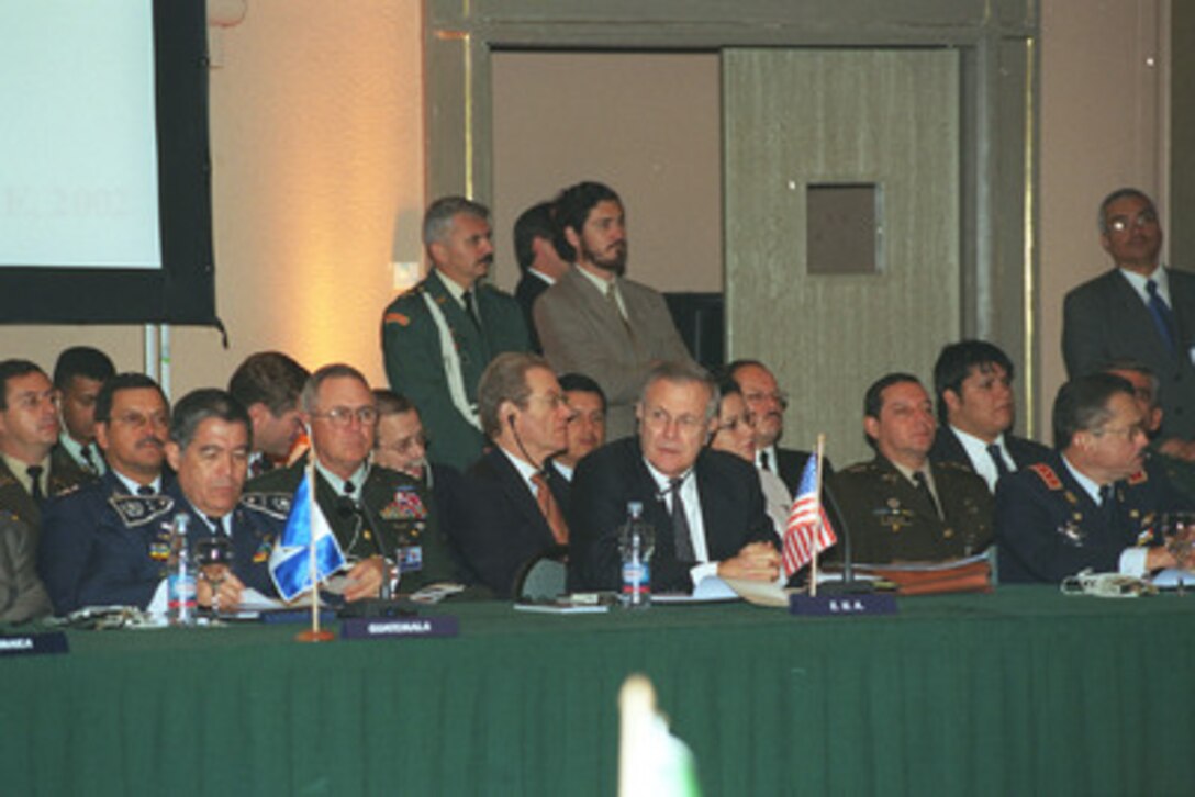 Secretary of Defense Donald H. Rumsfeld (center) listens to opening remarks by President Ricardo Lagos during the Defense Ministerial of the Americas in Santiago, Chile, on Nov. 19, 2002. Rumsfeld is attending the meeting to offer two initiatives to foster security and draw Western Hemisphere nations closer together. 
