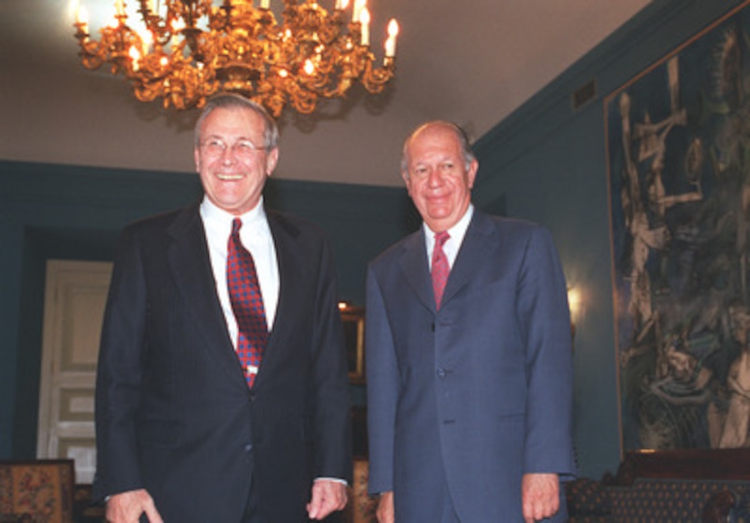 Secretary of Defense Donald H. Rumsfeld and Chilean President Ricardo Lagos pose for photographers prior to their formal meeting at La Moneda in Santiago, Chile, on Nov.18, 2002. Rumsfeld is in Santiago to attend the Defense Ministerial of the Americas. 