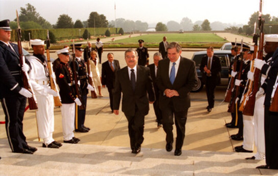 Turkish Deputy Prime Minister and Minister of Foreign Affairs Sikru Sina Gurel (left) arrives at the Pentagon, on Sept. 18, 2002, for a meeting with Deputy Secretary of Defense Paul Wolfowitz (right). A broad range of regional security issues are expected to be discussed. 