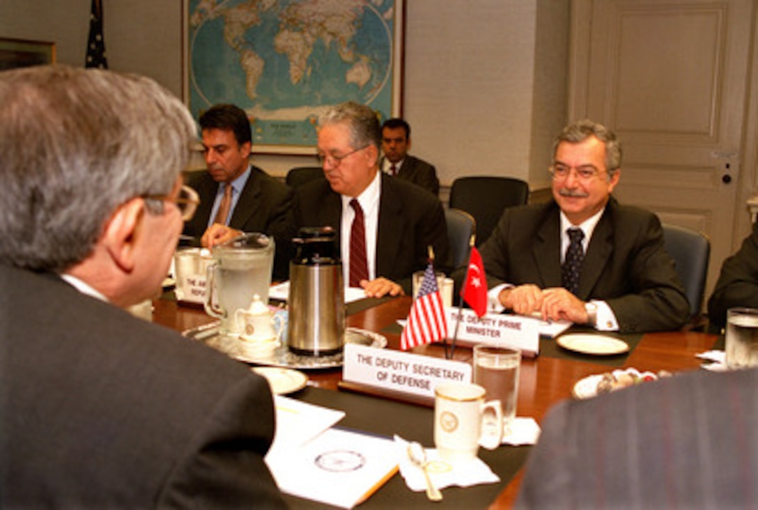 Deputy Prime Minister Sikru Sina Gurel (right), of Turkey, meets with Deputy Secretary of Defense Paul Wolfowitz (foreground) in the Pentagon on Sept. 18, 2002. Gurel and Wolfowitz are meeting to discuss a broad range of regional issues. Also participating in the talks is Turkish Ambassador to the U.S. Osman Faruk Logoglu (center) and Yusuf Buluc, deputy under secretary for Overseas Promotion and Cultural Affairs (left). 