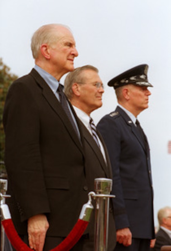 U.S. Congressman Sam Johnson, of Texas, Secretary of Defense Donald H. Rumsfeld and Chairman of the Joint Chiefs of Staff Gen. Richard B. Myers, U.S. Air Force, watch the troops pass in review during the National POW/MIA Recognition Day ceremony at the Pentagon on Sept. 20, 2002. Johnson, an Air Force fighter pilot during the Korean and Vietnam Wars, spent seven years in captivity in Hanoi, Vietnam, after his F-4 Phantom was shot down on his 25th combat mission of that war. Johnson was the keynote speaker for the ceremony. 