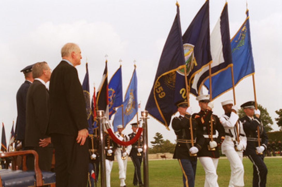 U.S. Congressman Sam Johnson (right), of Texas, Secretary of Defense Donald H. Rumsfeld (center) and Chairman of the Joint Chiefs of Staff Gen. Richard B. Myers (left), U.S. Air Force, watch as the state and territorial flags of the United States pass in review at the close of the National POW/MIA Recognition Day observance at the Pentagon on Sept. 20, 2002. Johnson, an Air Force fighter pilot during the Korean and Vietnam Wars, spent seven years in captivity in Hanoi, Vietnam, after his F-4 Phantom was shot down on his 25th combat mission of that war. 