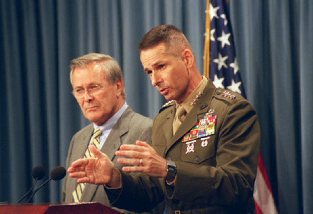 Vice Chairman of the Joint Chiefs of Staff Gen. Peter Pace and Secretary of Defense Donald H. Rumsfeld brief reporters in the Pentagon on Oct. 7, 2002. The day marked the first anniversary of U.S. strikes against Taliban and al-Qaeda forces in Afghanistan. 