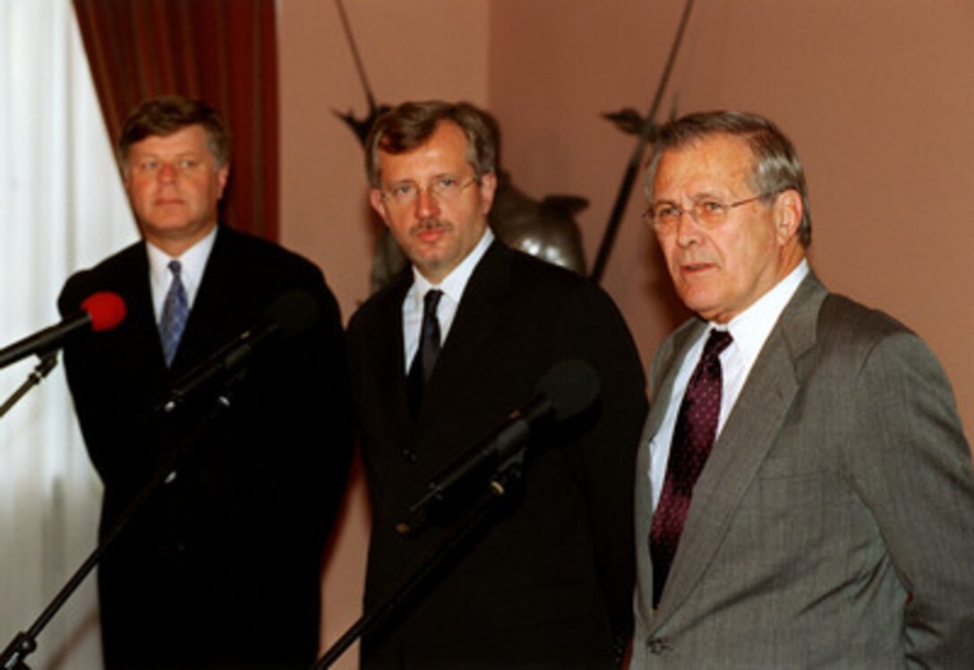 Secretary of Defense Donald H. Rumsfeld (right), Polish Minister of National Defense Jerzy Szmajdzinski (left) and National Security Minister Marek Siwiec (center) participate in a joint press conference at the Presidential Palace in Warsaw, Poland, on Sept. 23, 2002. Rumsfeld is in Warsaw in conjunction with the annual autumn informal meeting of NATO defense ministers. 