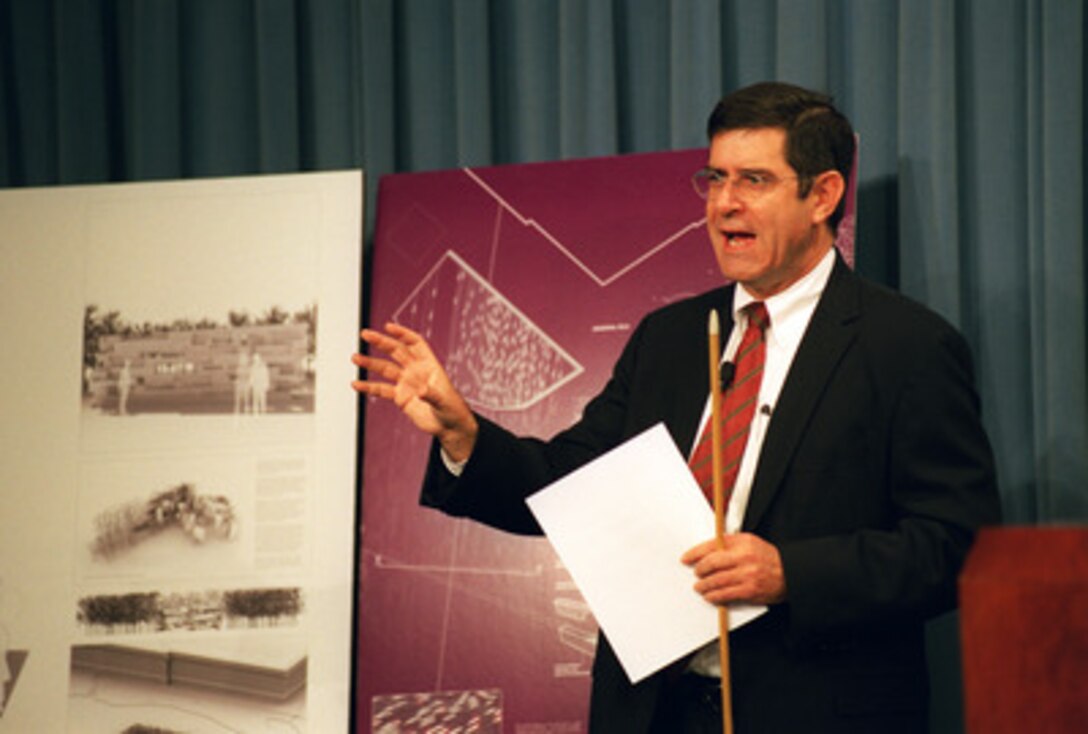 Terry Riley tells reporters about the six designs selected as finalists in the competition for a memorial to those who lost their lives in the Sept. 11, 2001, terrorist attack on the Pentagon during a Pentagon press briefing on Oct. 17, 2002. Over 1,100 architectural design proposals were submitted from all over the world. The memorial will be built on the western side of the Pentagon adjacent to the site of the aircraft impact. Riley, a panel member for the design competition, is the chief curator of design and architecture at the New York Museum of Modern Art. 