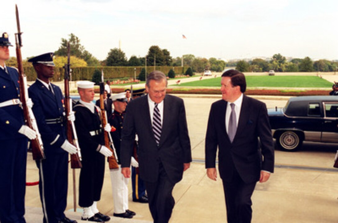 Secretary of Defense Donald H. Rumsfeld escorts NATO Secretary General Lord George Robertson into the Pentagon on Oct. 21, 2002. Rumsfeld and Robertson will meet to discuss defense issues of mutual interest. 