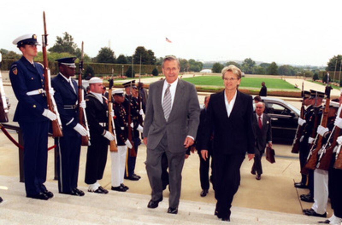 Secretary of Defense Donald H. Rumsfeld escorts French Minister of Defense Michele Alliot-Marie into the Pentagon on Oct. 17, 2002. Rumsfeld and Alliot-Marie will meet to discuss defense issues of mutual interest. 